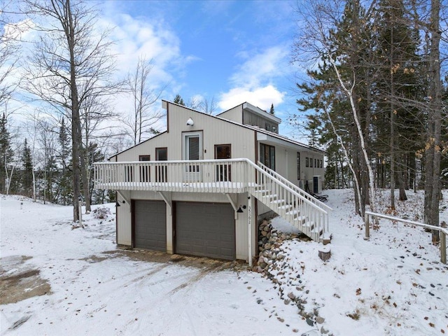 view of front of property with central AC unit and a garage