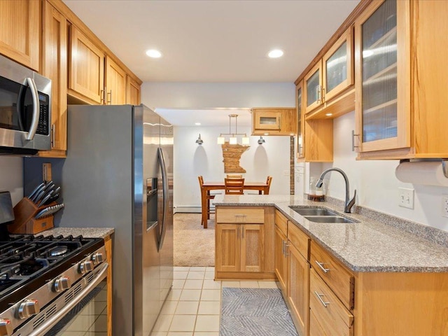 kitchen with decorative light fixtures, sink, light tile patterned floors, stainless steel appliances, and light stone countertops