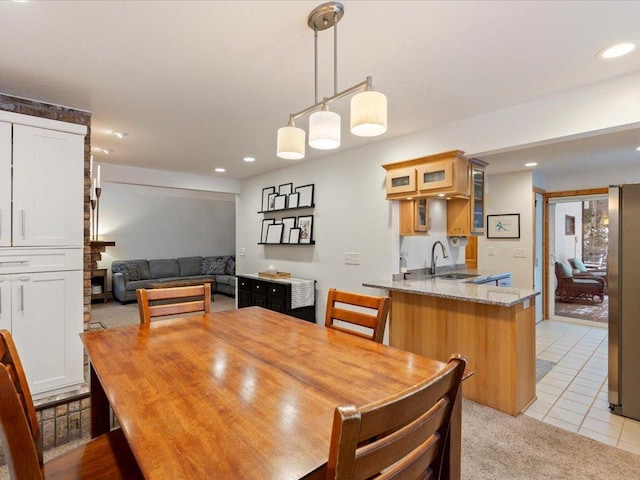 dining area featuring light tile patterned flooring and sink