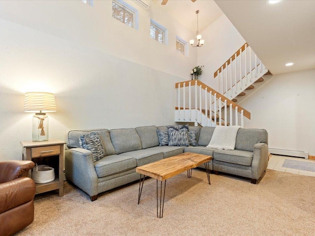 carpeted living room featuring a notable chandelier, a baseboard radiator, and a high ceiling