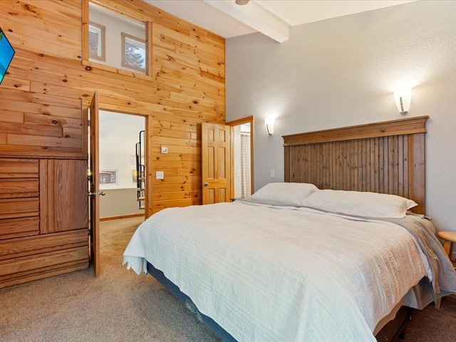 carpeted bedroom featuring wooden walls and beamed ceiling