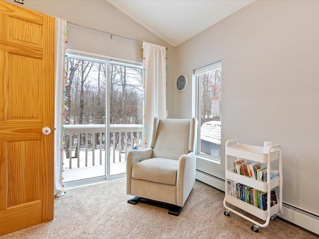 living area featuring lofted ceiling, a baseboard heating unit, and carpet flooring