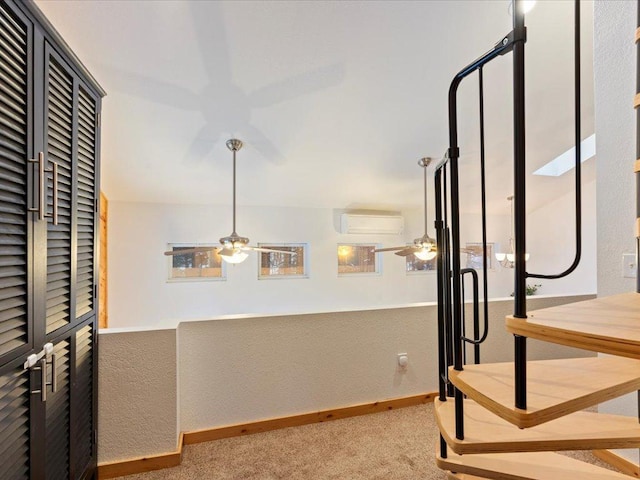 corridor featuring light carpet and an AC wall unit