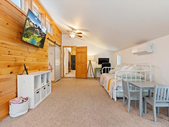 bedroom featuring a wall mounted air conditioner, vaulted ceiling, a barn door, and wood walls