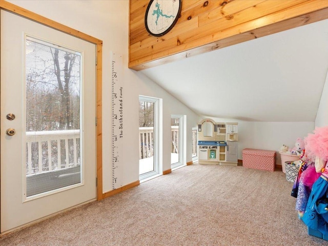 playroom featuring vaulted ceiling, plenty of natural light, and carpet floors