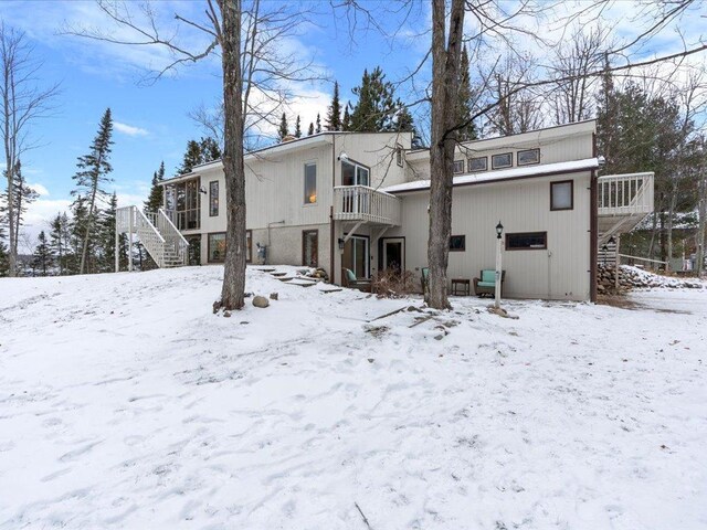 view of snow covered back of property