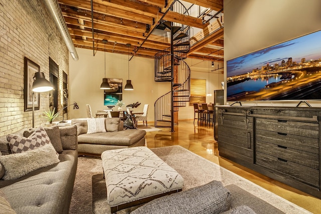 living room with brick wall and a towering ceiling