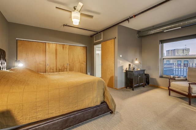 bedroom with ceiling fan and light colored carpet