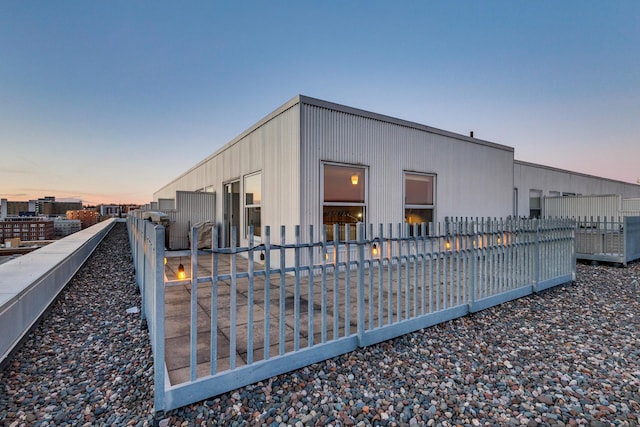 view of back house at dusk