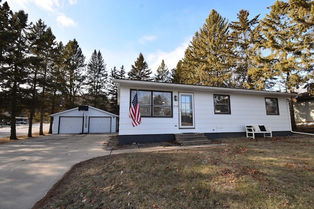 view of front of house with an outbuilding, a garage, and a front yard