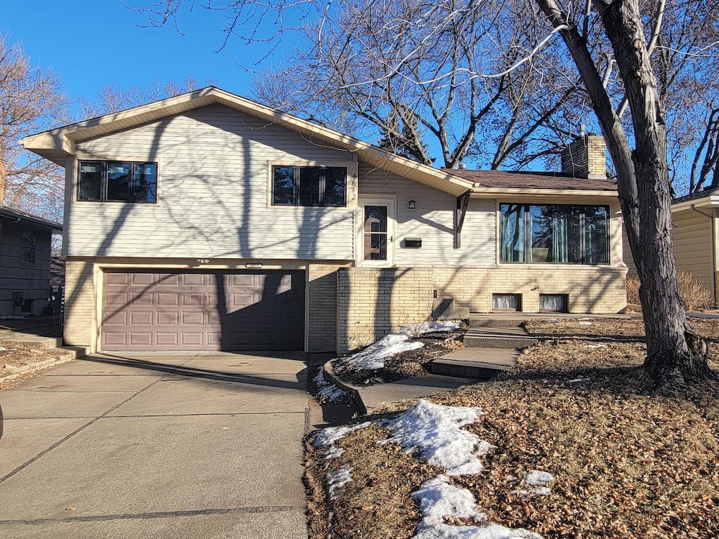 rear view of house featuring a garage