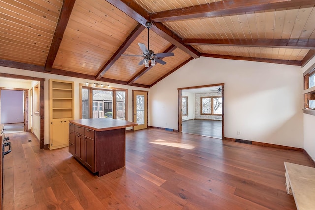 kitchen featuring wood ceiling, a center island, lofted ceiling with beams, and light wood-type flooring