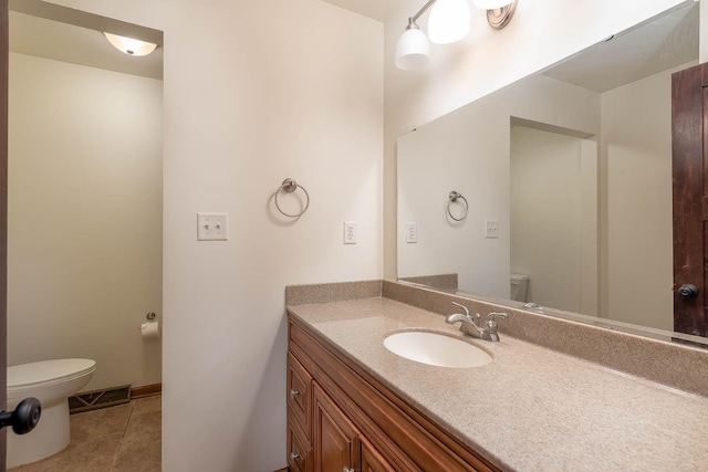 bathroom featuring tile patterned flooring, vanity, and toilet