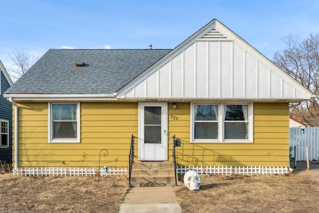 bungalow with a shingled roof, entry steps, and crawl space