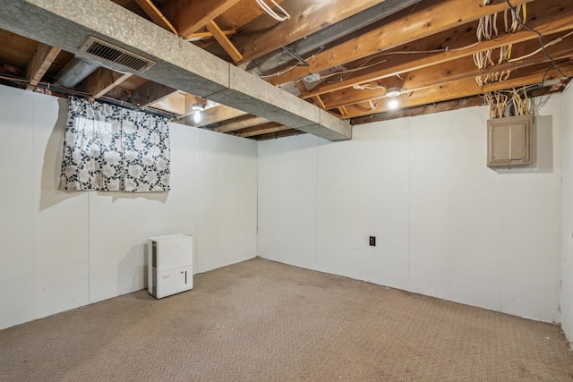 unfinished basement featuring visible vents and light colored carpet