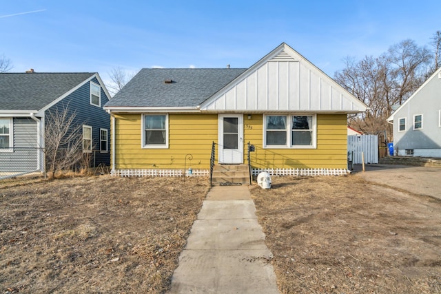 bungalow-style home with crawl space, board and batten siding, a shingled roof, and fence