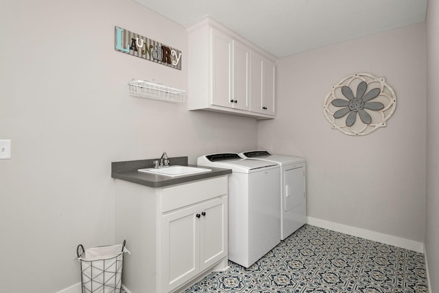 washroom with separate washer and dryer, sink, and cabinets