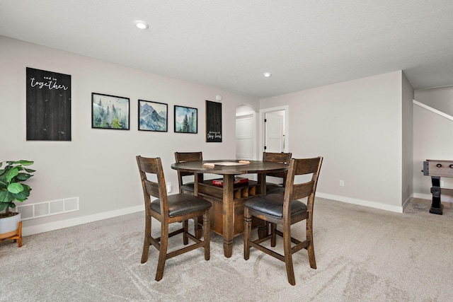 dining area featuring light colored carpet