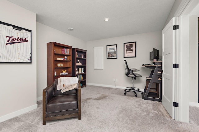 carpeted office space with a textured ceiling