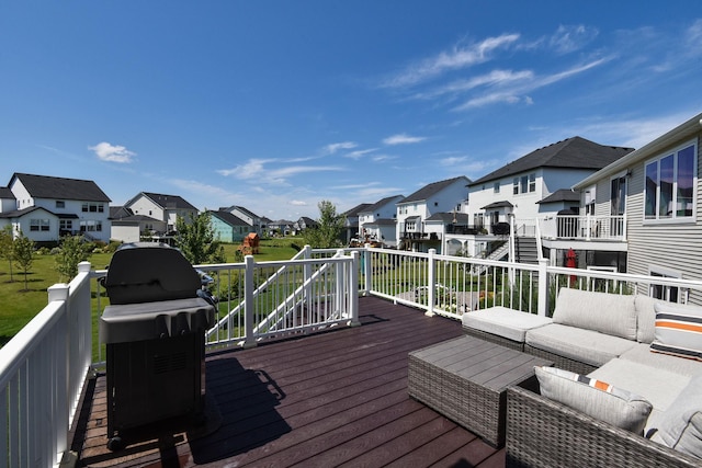 wooden deck featuring area for grilling and an outdoor hangout area