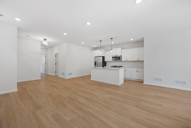 unfurnished living room with recessed lighting, baseboards, visible vents, and light wood-type flooring