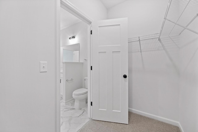 bathroom featuring toilet and baseboards