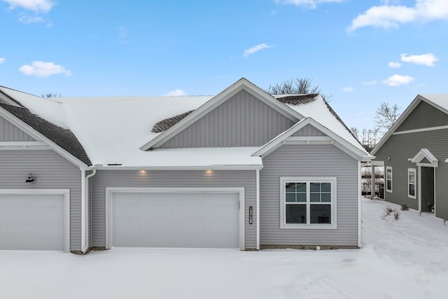 view of front facade with board and batten siding and an attached garage