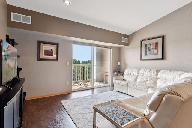 living room featuring lofted ceiling and dark hardwood / wood-style floors