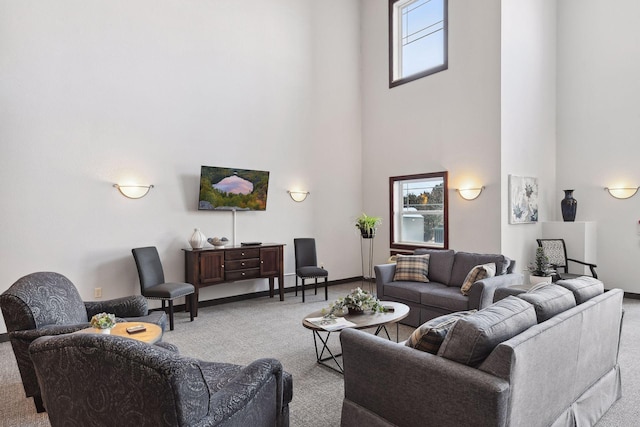 carpeted living room with a towering ceiling