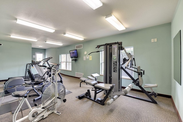 exercise room featuring a textured ceiling