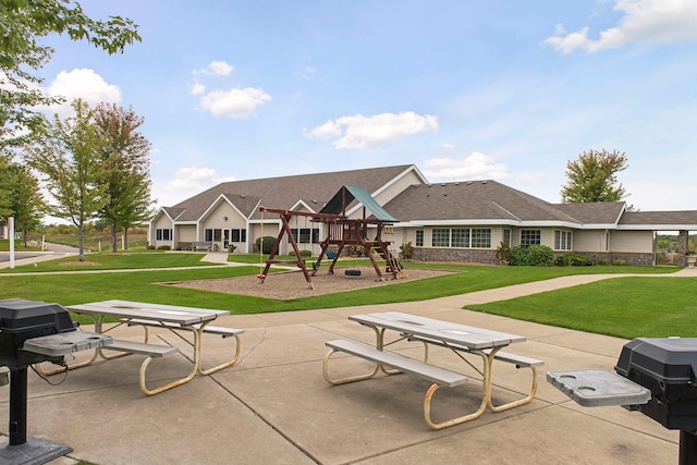 surrounding community featuring a playground, a yard, and a patio area