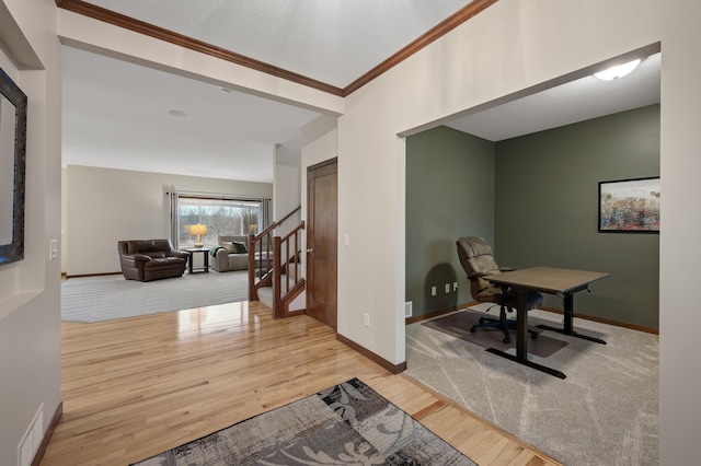 office area with ornamental molding, visible vents, baseboards, and wood finished floors