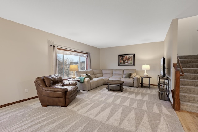 living room featuring stairs and baseboards