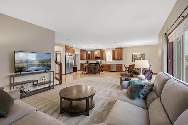 living room featuring light wood-type flooring, recessed lighting, and an inviting chandelier