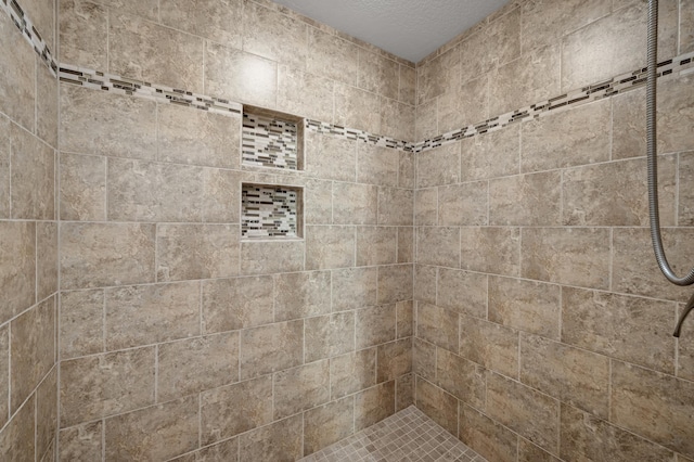 full bath with a tile shower