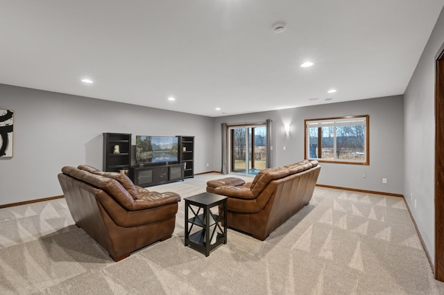 living area with light carpet, recessed lighting, and baseboards