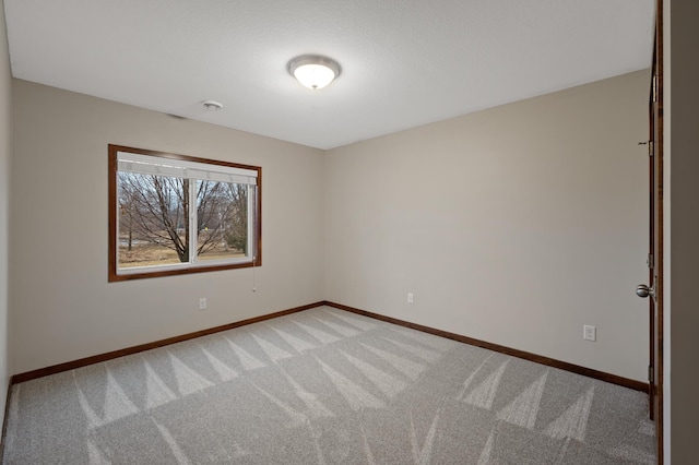 empty room with light carpet and baseboards