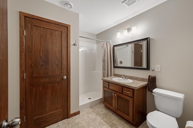 full bathroom featuring toilet, a stall shower, vanity, and visible vents