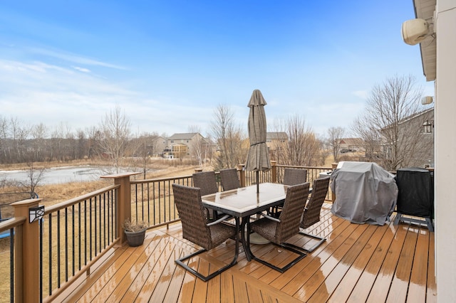 deck with outdoor dining space and area for grilling