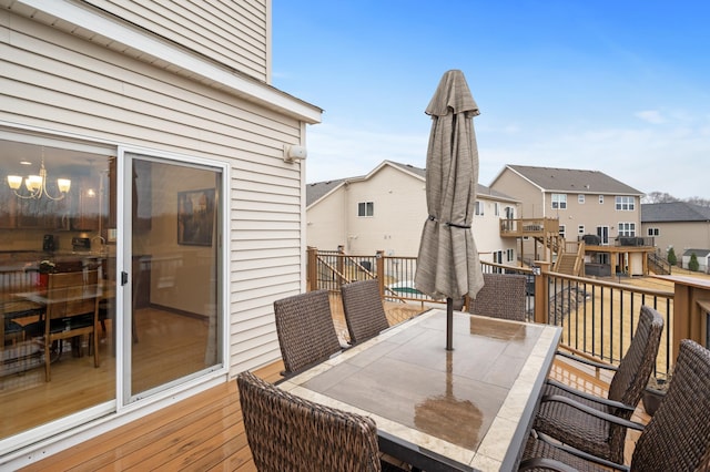 wooden deck with a residential view and outdoor dining area