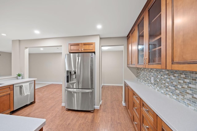 9700 Portland Ave S Unit 226, Bloomington, MN 55420 - kitchen featuring appliances with stainless steel finishes, decorative backsplash, baseboards, light wood finished floors, and recessed lighting