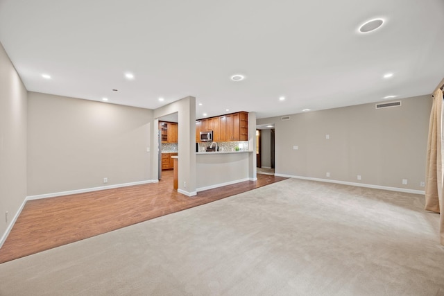 9700 Portland Ave S Unit 226, Bloomington, MN 55420 - unfurnished living room with light colored carpet, baseboards, and recessed lighting