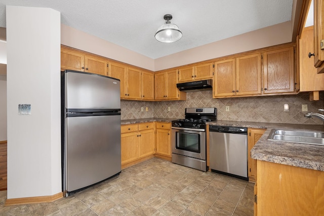 kitchen featuring tasteful backsplash, sink, and appliances with stainless steel finishes