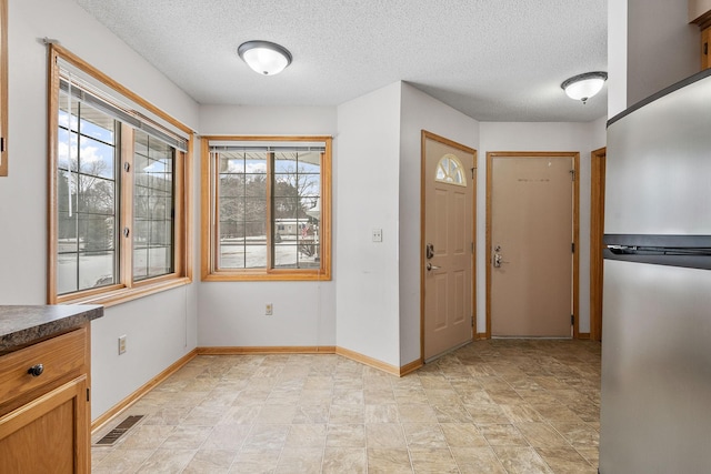 foyer with a textured ceiling