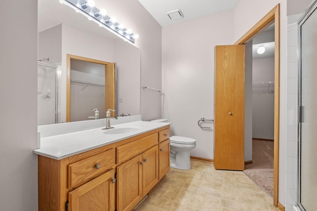 bathroom with vanity, toilet, and walk in shower