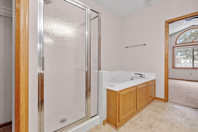 bathroom featuring shower with separate bathtub