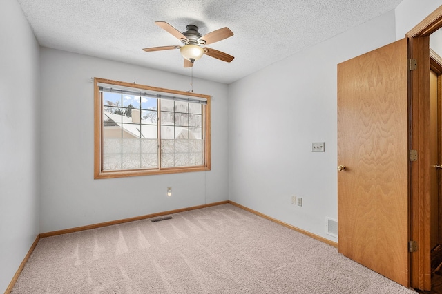 empty room featuring carpet floors, a textured ceiling, and ceiling fan