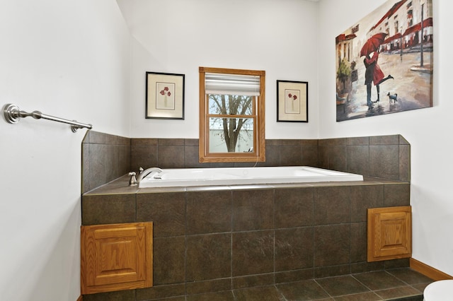 bathroom with tile patterned flooring and tiled bath