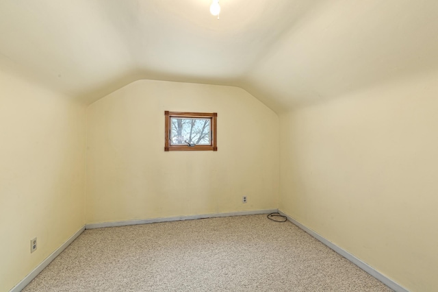 additional living space with lofted ceiling and carpet floors