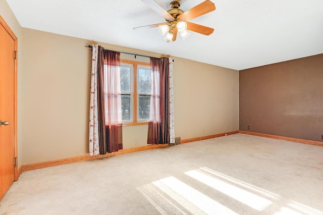 unfurnished room featuring light colored carpet and ceiling fan